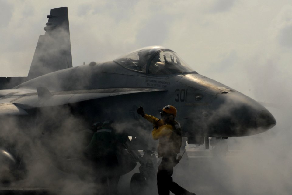 US Navy 070209-N-3038W-163 A flight deck director instructs the pilot of an F-A-18C Hornet from the Blue Diamonds