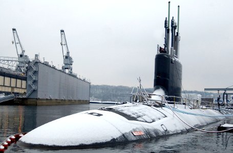 US Navy 070202-N-8467N-002 Attack submarine USS Virginia (SSN 774) is covered in snow and moored to the pier at Submarine Base New London photo