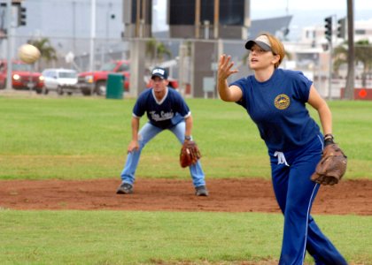 US Navy 070209-N-4965F-026 Master-at-Arms 1st Class Jinine Green, assigned to Naval Station Pearl Harbor Security, pitches a softball during a Chief Petty Officer's Association versus 1st Class Petty Officer's Assoc