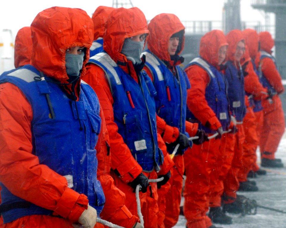 US Navy 070207-N-5345W-015 Deck department Sailors manning the phone and distance line bundle up against the cold and snow on the flight deck of the Nimitz-class aircraft carrier USS Harry S. Truman (CVN 75) during an ammunitio