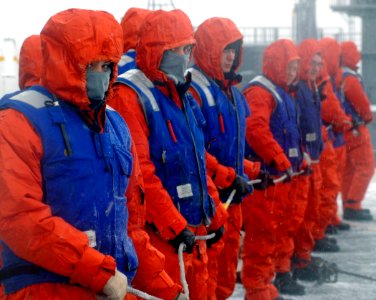 US Navy 070207-N-5345W-015 Deck department Sailors manning the phone and distance line bundle up against the cold and snow on the flight deck of the Nimitz-class aircraft carrier USS Harry S. Truman (CVN 75) during an ammunitio
