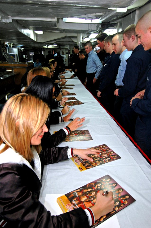 US Navy 070209-N-7883G-037 Sailors stationed aboard USS Kitty Hawk (CV 63) wait in line for autographs from the Tampa Bay Buccaneers Cheerleaders