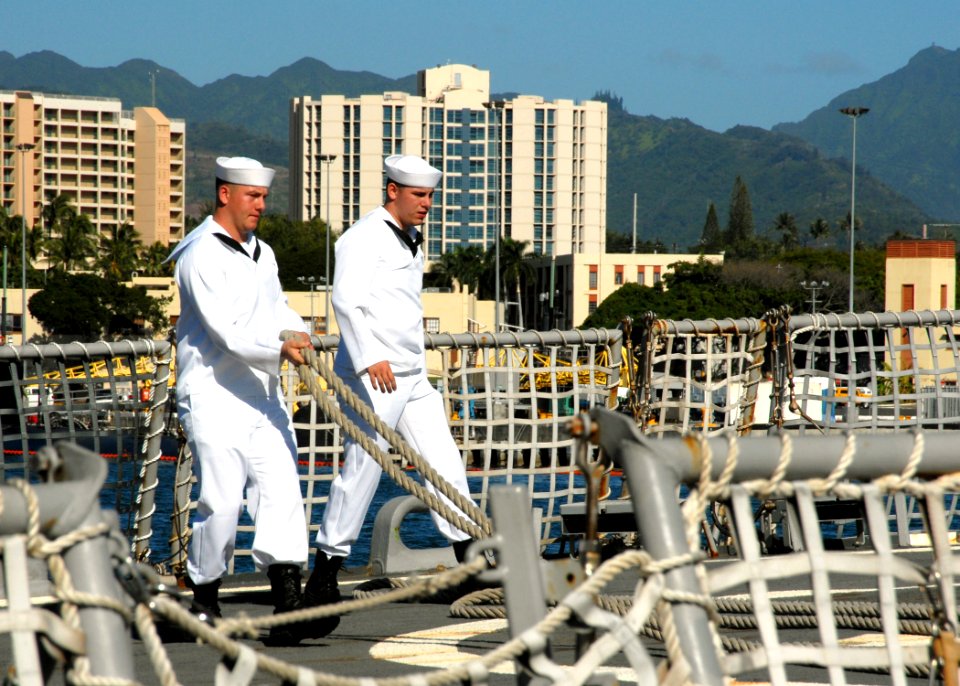 US Navy 070203-N-4965F-004 Sailors lay out mooring lines on the flight deck of guided missile destroyer USS Russell (DDG 59) prior to getting underway from Naval Station Pearl Harbor