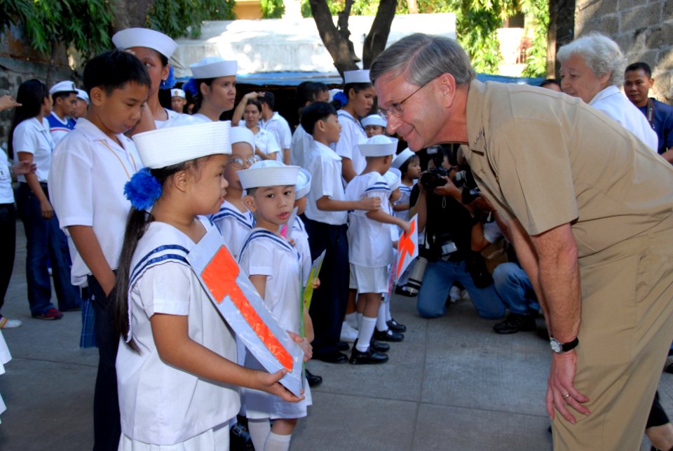 US Navy 070209-N-9860Y-331 Commander, U.S. 7th Fleet, Vice Adm. Doug Crowder thanks a student from Manila's Trichet Learning Center for her performance during a community service project