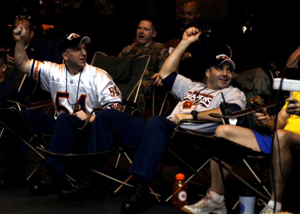 US Navy 070205-N-5330L-002 A few Chicago Bears fans aboard Nimitz-class aircraft carrier USS Dwight D. Eisenhower (CVN 69) celebrate together in the ship's hangar bay after watching Devin Hester return the opening kickoff