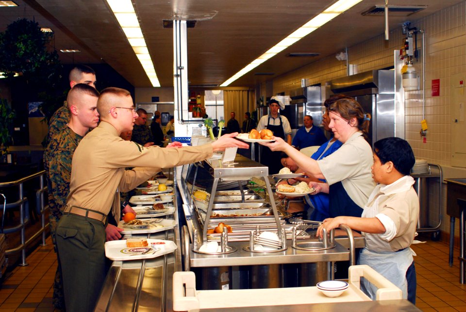 US Navy 070206-N-1831S-046 Kitchen staff workers serve lunch to base personnel. Gator Inn, the Naval Amphibious Base Little Creek galley, was awarded first place in the continental U.S. ashore general mess category