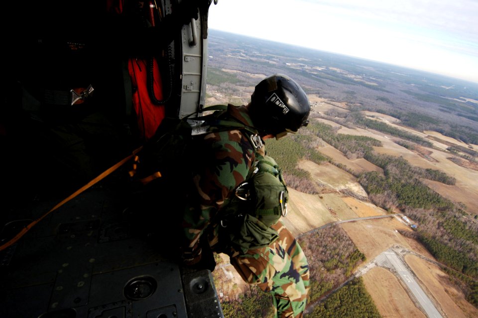 US Navy 070208-N-7918H-168 A Sailor assigned to Explosive Ordnance Disposal Unit Two (EODMU-2) jumps from an MH-60S Seahawk assigned to the Chargers of Helicopter Combat Support Squadron Two Six (HSC-26)
