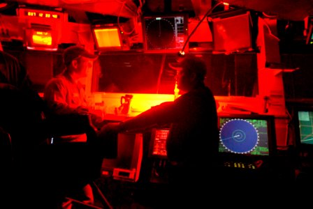 US Navy 070206-N-4133B-077 Assistant Navigator Lt. Cmdr. Paul Crawford and Lt. j.g. Kevin Wall discusses cruising speed on the bridge aboard USS Ronald Reagan (CVN 76)