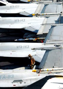 US Navy 070208-N-8907D-004 A Sailor assigned to theRampagers of Strike Fighter Squadron Eight Three (VFA-83) wipes down an F-A-18C Hornet on the flight deck of Nimitz-class aircraft carrier USS Dwight D. Eisenhower (CVN