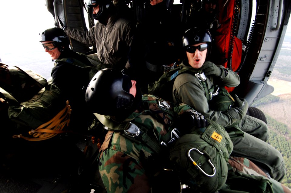 US Navy 070208-N-7918H-120 Sailors assigned to Explosive Ordnance Disposal Unit Two (EODMU-2), prepare to conduct static-line jump operations aboard an MH-60S Seahawk