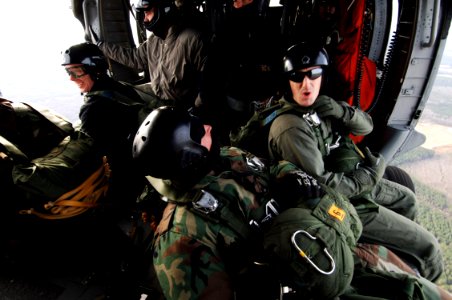 US Navy 070208-N-7918H-120 Sailors assigned to Explosive Ordnance Disposal Unit Two (EODMU-2), prepare to conduct static-line jump operations aboard an MH-60S Seahawk