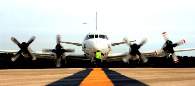 US Navy 070213-N-1810F-050 Airman Jesse Baron assigned to Pro's Nest of Patrol Squadron Three Zero (VP-30) signals to the crew of a P-3C Orion during start-up checks