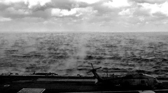 US Navy 070206-N-5345W-069 An SH-60 Seahawk assigned to the Tridents of Helicopter Anti-Submarine Squadron Three (HS-3) sits chocked and chained to the flight deck as sea smoke blankets the water's surface