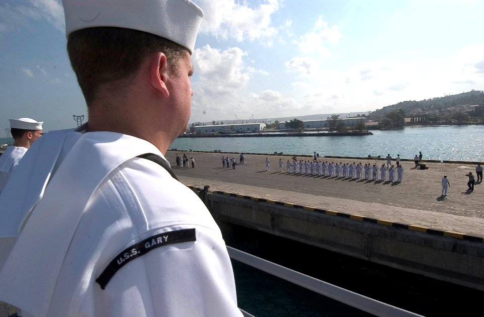 US Navy 070209-N-8534H-001 Guided missile frigate USS Gary (FFG 51) Sailors man the rails as Royal Cambodian Navy sailors stand in formation to welcome the first U.S. Navy ship to visit Cambodia in 30 years