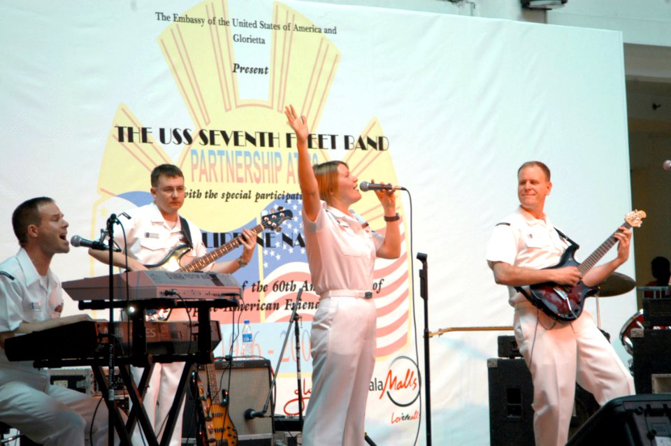 US Navy 070209-N-2468S-002 Musician 2nd Class Jessica Hatfield belts out a crowd-pleasing tune as she and rest of the 7th Fleet rock band perform during a public concert held at Glorietta Mall