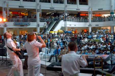 US Navy 070209-N-2468S-001 Members of the 7th Fleet rock band entertain the crowd with popular tunes during a public concert held at Glorietta Mall photo