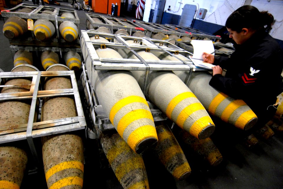 US Navy 070208-N-5345W-030 Aviation Ordnanceman 2nd Class Marilyn Marquez inventories pallets of MK 83-BLU-110 general-purpose bombs in the hangar bay aboard Nimitz-class aircraft carrier USS Harry S. Truman's (CVN 75) during a