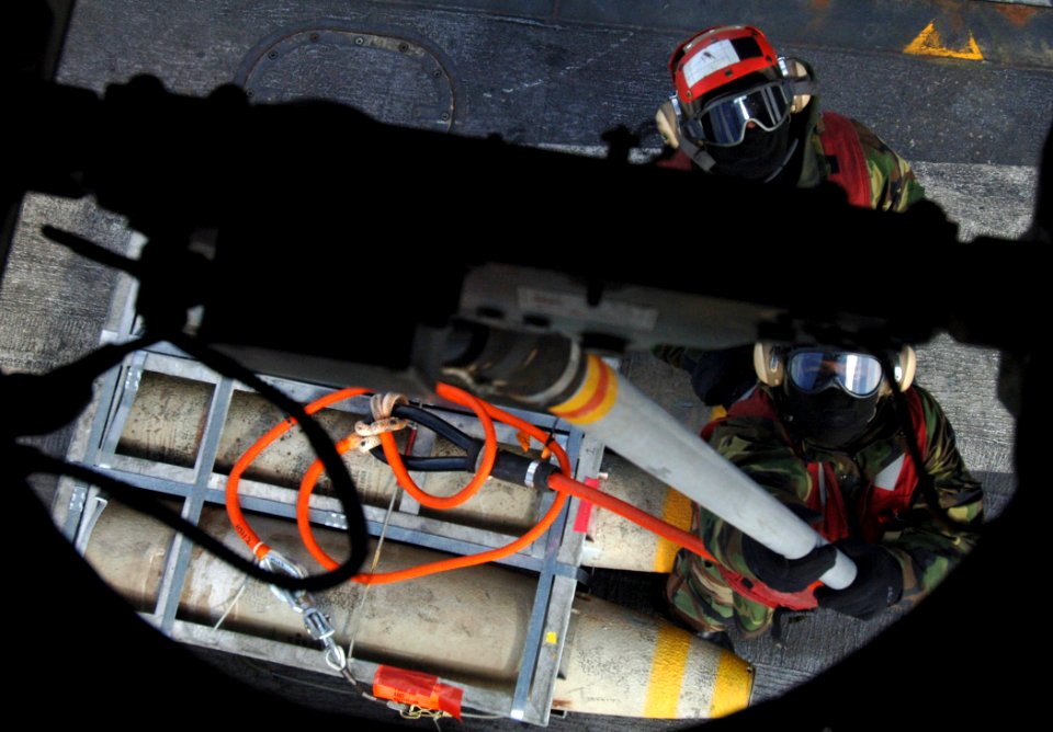 US Navy 070208-N-0535P-122 Sailors assigned to the weapons department aboard Nimitz-class aircraft carrier USS Theodore Roosevelt (CVN 71) attach a replenishment pendant to an SH-60S Seahawk during an ammunition cross-deck with