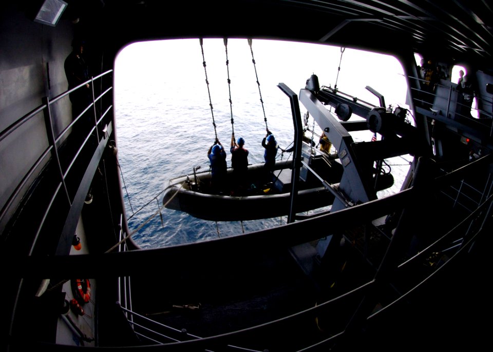 US Navy 070208-N-8446A-009 Members of the surface search and rescue team raise a Rigid Hull Inflatable Boat (RHIB) during a man overboard drill aboard Nimitz-class aircraft carrier USS Dwight D. Eisenhower (CVN 69)