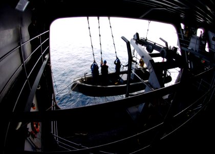 US Navy 070208-N-8446A-009 Members of the surface search and rescue team raise a Rigid Hull Inflatable Boat (RHIB) during a man overboard drill aboard Nimitz-class aircraft carrier USS Dwight D. Eisenhower (CVN 69)