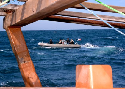 US Navy 070209-N-8623S-010 A rigid-hull inflatable boat from guided missile destroyer USS Ramage (DDG 61) circles a fishing dhow while boarding team members conduct visit, board, search and seizure (VBSS) operations aboard the