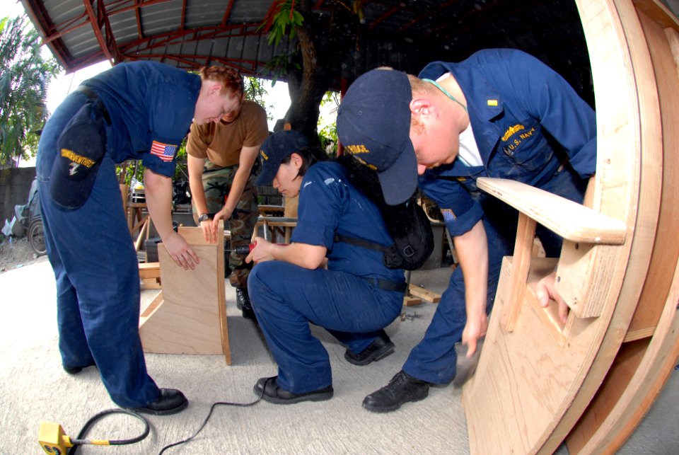 US Navy 070209-N-9860Y-626 Ensign Jeffrey Chewning of Germantown, Md., Fire Controlman 2nd Class Autumn Skalany of Crystal Lake, Ill., and Damage Controlman Fireman Abba Yeen Leon of Los Angeles, build furniture for children of