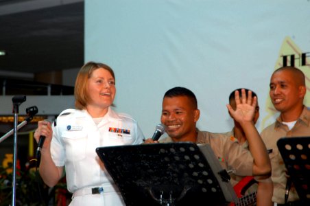 US Navy 070209-N-2468S-003 Musician 2nd Class Jessica Hatfield, left, performs alongside Republic of Philippines sailors during a public concert held at Glorietta Mall