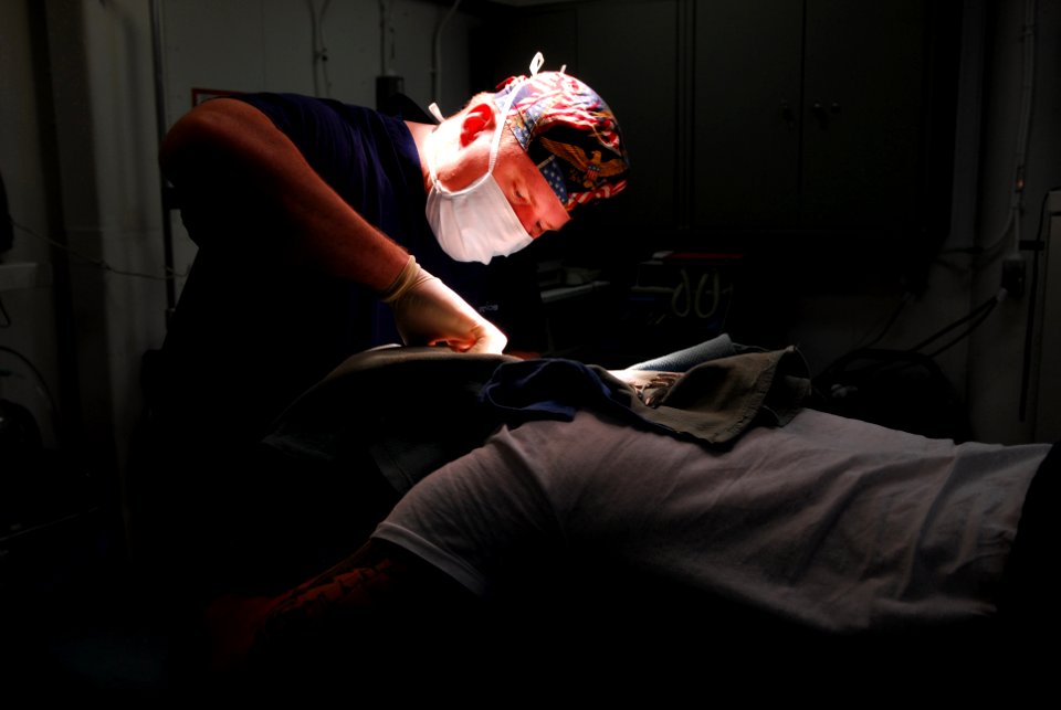 US Navy 070210-N-9760Z-042 Lt. Cmdr. John Ullrich performs cranial surgery on a crewmember aboard the nuclear-powered aircraft carrier USS Nimitz (CVN 68)