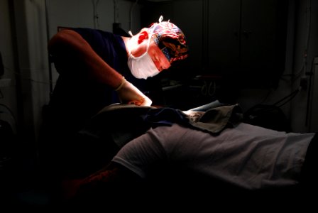 US Navy 070210-N-9760Z-042 Lt. Cmdr. John Ullrich performs cranial surgery on a crewmember aboard the nuclear-powered aircraft carrier USS Nimitz (CVN 68)