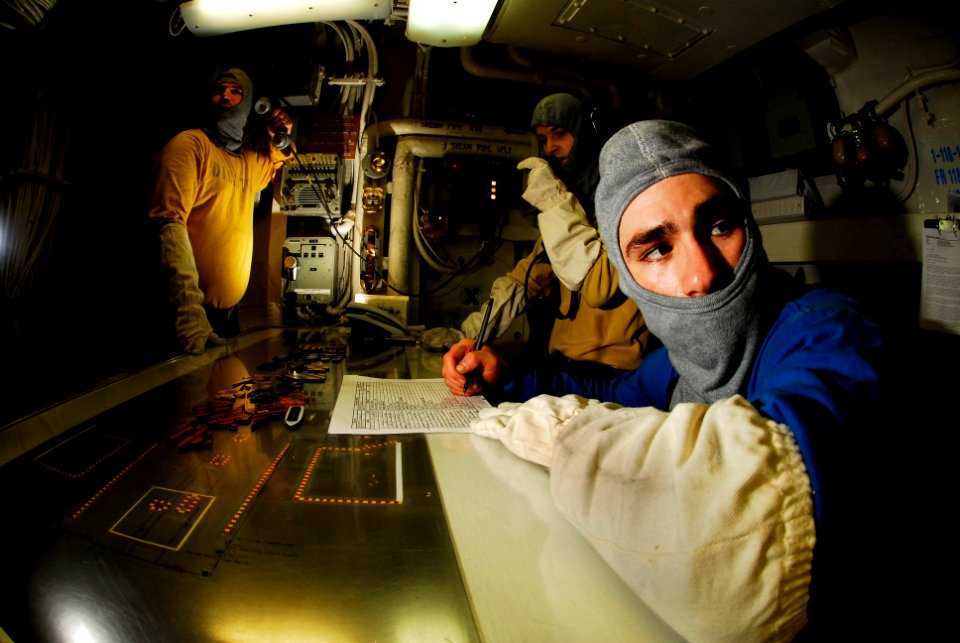 US Navy 070217-N-3729H-049 From left to right, Aviation Boatswain's Mate Airman Eric Labrecque, Airman Thomas Gerold, and Aviation Boatswain's Mate 3rd Class Dusty Garcia stand watch in hangar deck control