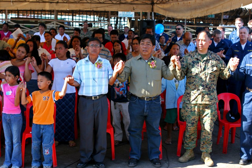 US Navy 070218-N-1113S-004 Sailors and Marines join hands with community members for a prayer at Changco Elementary School