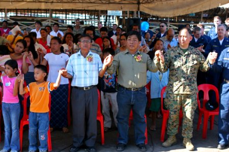 US Navy 070218-N-1113S-004 Sailors and Marines join hands with community members for a prayer at Changco Elementary School