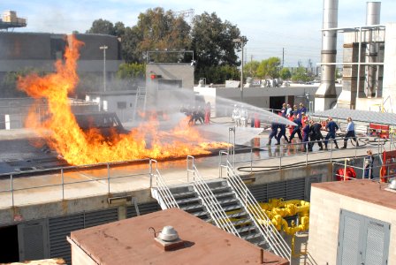 US Navy 070208-N-9195K-046 Sailors from USS John Paul Jones (DDG 53) begin attacking a simulated flight deck fire at the Aircraft Firefighting class held at Naval Base San Diego's firefighting school