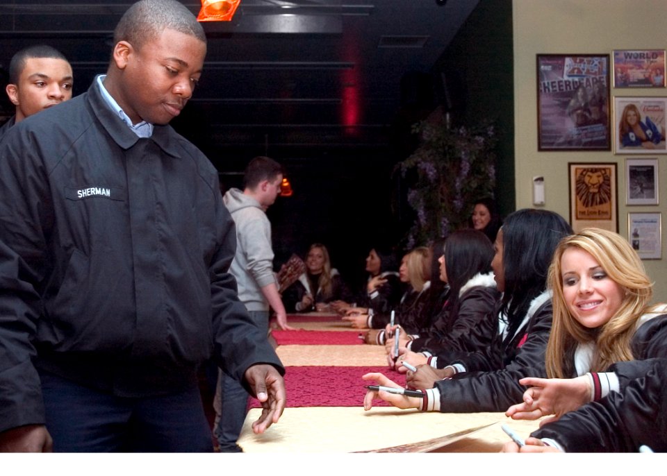US Navy 070209-N-2638R-005 Culinary Specialist Seaman Cortez Sherman meets members of the Tampa Bay Buccaneers Cheerleading Squad at the Spectrum Lounge on board Commander Fleet Activities Yokosuka