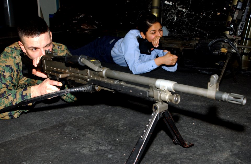US Navy 070213-N-2143T-002 Pfc. Damon Vianueva and Master-at-Arms Seaman Alvethy Mendoza practice with a training machine gun in a Fire Arm Training Simulator (FATS)