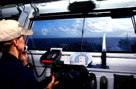US Navy 070214-N-4009P-024 Officer of the Deck (OOD), Lt. Cmdr. Karen Sray from Bidgeton, N.J., watches the Military Sealift Command (MSC) combat stores ship USNS Niagara Falls (T-AFS 3) from the bridge of the Nimitz-class air