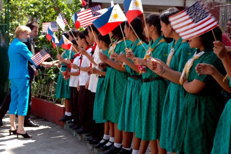 US Navy 070209-N-9604C-171 U.S. Ambassador to the Philippines Kristie Kenney and Deputy Chief of Mission for the U.S. Embassy in Manila Paul Jones are greeted by Manila High School students photo