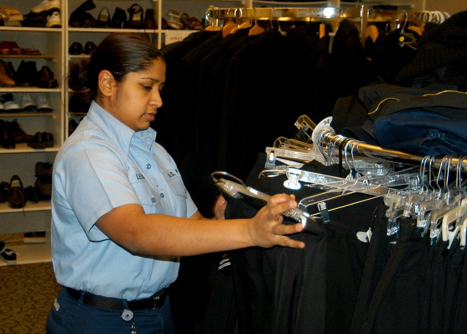 US Navy 070215-N-6247M-003 Aviation Structural Mechanic Equipment Airman Kimberly Leonard, from Fort Lauderdale, Fla., looks at military uniforms in the Navy Marine Corps Relief Society (NMCRS) Thrift Store