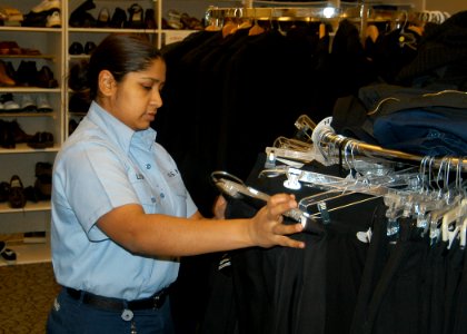 US Navy 070215-N-6247M-003 Aviation Structural Mechanic Equipment Airman Kimberly Leonard, from Fort Lauderdale, Fla., looks at military uniforms in the Navy Marine Corps Relief Society (NMCRS) Thrift Store