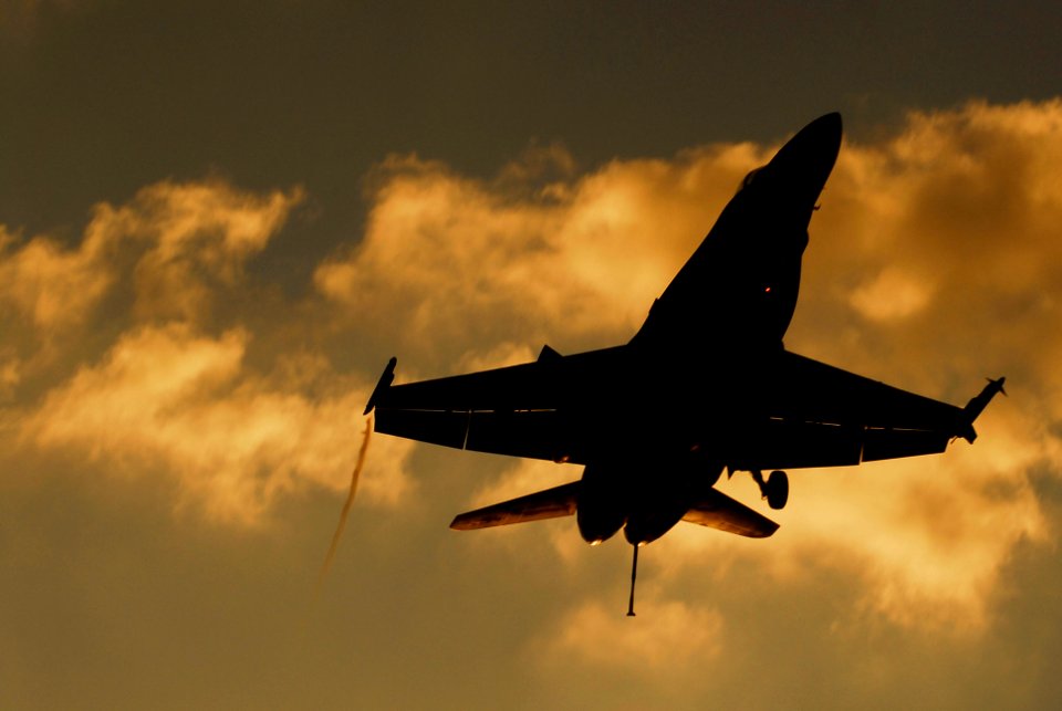 US Navy 070216-N-3729H-083 An F-A-18C Hornet from the Blue Diamonds of Strike Fighter Squadron One Four Six (VFA-146) flies over the flight deck of the Nimitz-class aircraft carrier USS John C. Stennis (CVN 74)