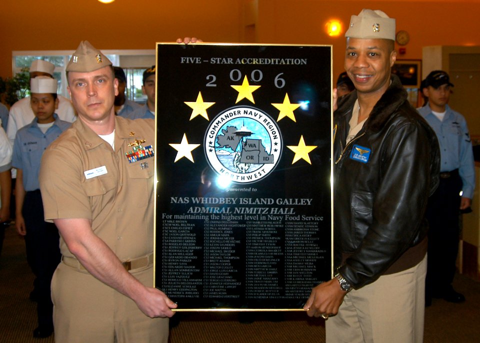 US Navy 070221-N-6247M-001 Commander, Naval Air Station Whidbey Island, Capt. Syd Abernethy, presents the five star accreditation award to Lt. Michael Brown
