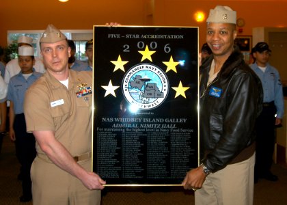 US Navy 070221-N-6247M-001 Commander, Naval Air Station Whidbey Island, Capt. Syd Abernethy, presents the five star accreditation award to Lt. Michael Brown photo