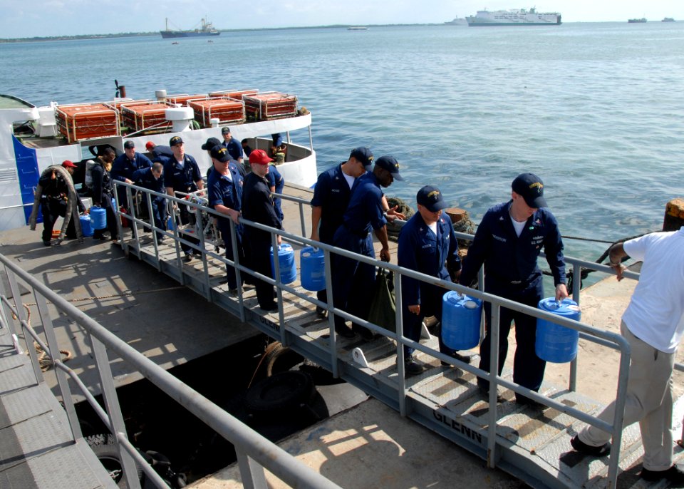 US Navy 070212-N-9860Y-542 Members of the rescue and assistance team aboard amphibious command ship USS Blue Ridge (LCC 19) carry damage control equipment up the ship's brow while preparing to render fire fighting and de-wateri