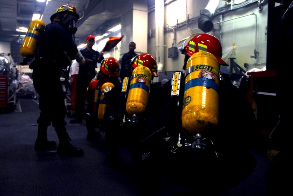 US Navy 070217-N-9928E-148 Sailors respond to a simulated fire during a general quarters (GQ) drill in a jet engine test shop aboard Nimitz-class aircraft carrier USS John C. Stennis (CVN 74)