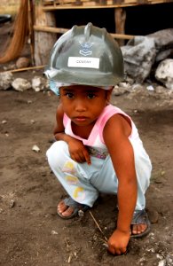 US Navy 070216-N-4198C-007 A four-year-old Filipino girl from the village of Changco, looks on as Seabees assigned to Naval Mobile Construction Battalion (NMCB) 3 work on the construction of a new school house