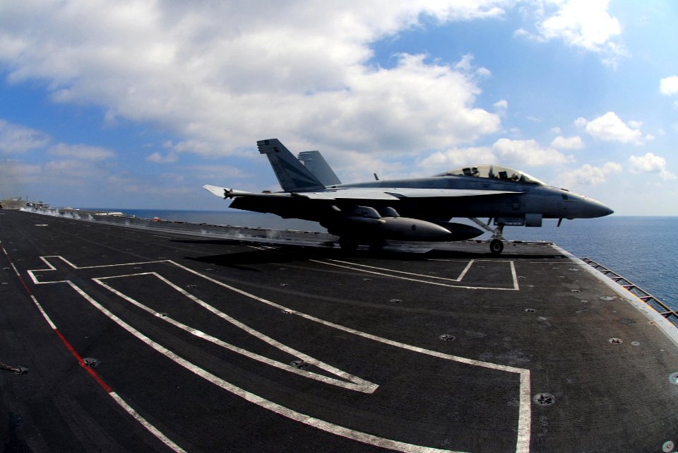 US Navy 070226-N-0684R-030 An F-A-18F Super Hornet assigned to the Black Knights of Strike Fighter Squadron (VFA) 154 passes over the number 74 painted on the flight deck
