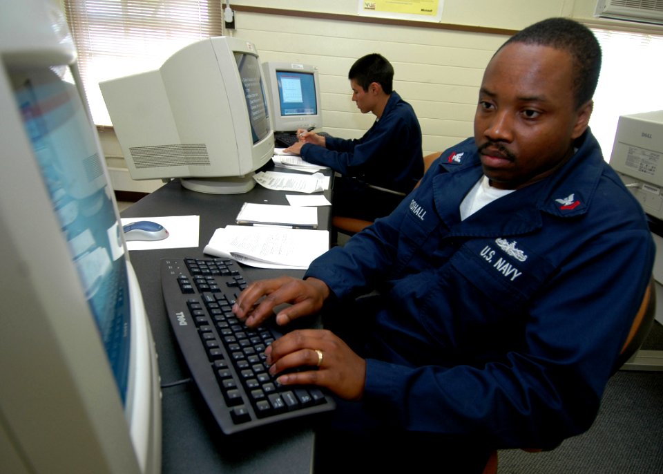 US Navy 070214-N-0879R-001 Information Systems Technician 2nd Class Frederick Marshall, assigned to guided missile destroyer USS Hopper (DDG 70), gets hands-on information technology (IT) training