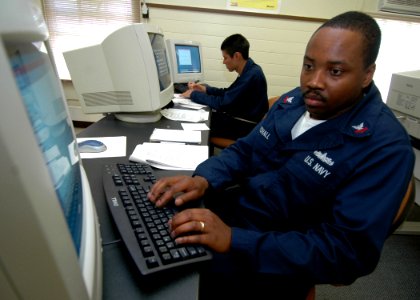 US Navy 070214-N-0879R-001 Information Systems Technician 2nd Class Frederick Marshall, assigned to guided missile destroyer USS Hopper (DDG 70), gets hands-on information technology (IT) training photo