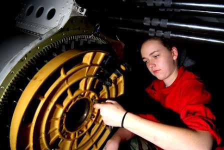 US Navy 070219-N-3038W-142 Aviation Ordnanceman Airman Chella Chance tightens the bolts on an M61A1 20mm machine-gun from an F-A-18 C Hornet in the Aviation Intermediate Maintenance Department