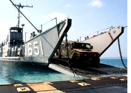 US Navy 070215-N-6710M-001 Hummers and Utility trucks are off loaded from Landing Craft Utility (LCU) 1651 assigned to USS Tortuga (LSD 46) onto the white beach shores of Okinawa, Japan photo